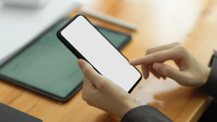 Female tapping finger on smartphone screen. mobile phone blank screen mockup