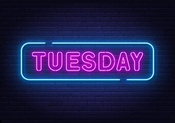 Tuesday neon sign on brick wall background.