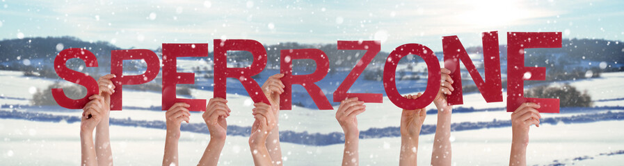 People Hands Holding Word Sperrzone Means Prohibited Area, Snowy Background