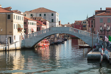 Fototapeta na wymiar Chioggia, Venezia. Ponte di Canal Vena con Palazzo Grassi