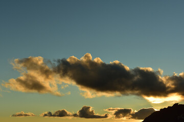 Setting sun in Keurboomstrand catching the clouds dramatically and silhouetting a tiny micro-light airplane