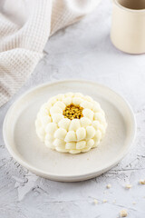 Mousse cake with honey, lemon and lavender on a light background.