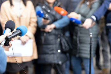 Fototapeta na wymiar Journalists at news conference or media event, microphone in the focus