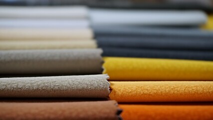Obraz premium Close-up colorful upholstery fabric samples background. Example for fabric catalog. Selective focus.