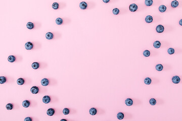 Berry background. Fresh berry blueberries on pink background. Flat lay, top view, copy space
