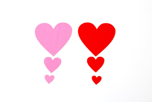 Red and pink heart graded from small to large isolated on a white background.