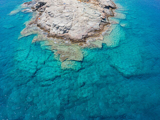 Azure water texture, transparent sea surface with a rocky bottom. Aerial view, Naxos,natural blue background