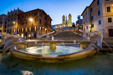 Naklejka premium The wonderful landscape that offers Piazza di Spagna in Rome with the famous staircase of Trinita dei monti and the fountain of the barcaccia