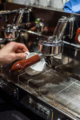 Closeup image of male hands pouring milk and preparing fresh cappuccino, coffee artist and preparation concept, morning coffee