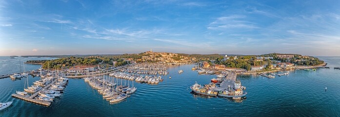 Drone panorama over the harbor of Croatian coastal town Vrsar in Istria during sunset