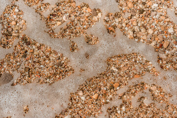 Small pebbles under the sea water on the beach