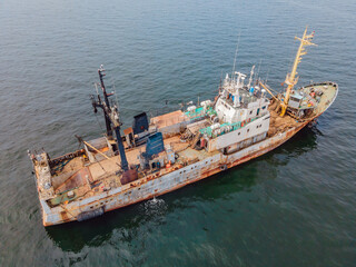 Old rusty ship at sea. Obsolescence of ships concept. Old ships pollute the environment