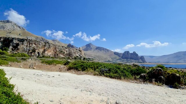 Panning to right at Baia Santa Margherita and surrounding landscape in western Sicily coast close to San Vito Lo Capo