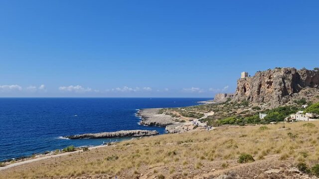 Panning of Baia Santa Margherita and torre Isulidda medieval watchtower in Sicily, southern Italy