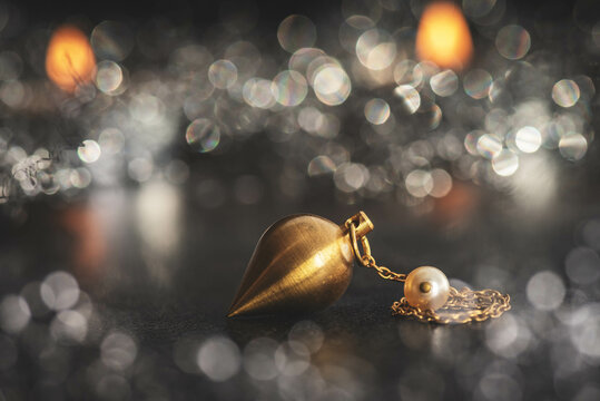 Pendel vor glitzernden Hintergrund. Hellseher und Wahrsagerin. Spiritualit&auml;t
