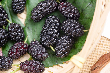 Ripe large black mulberries close up
