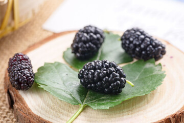 Ripe large black mulberries close up