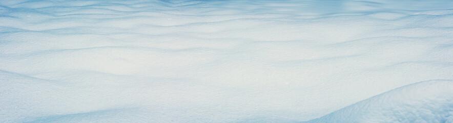 Panoramic view of the clear waved snowy field in winter.