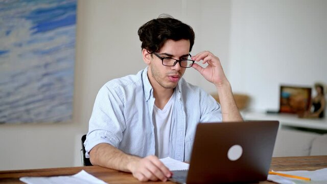 Tired jaded mixed race hispanic guy, employee, freelancer or student, in casual clothes, working or studying at laptop, experiencing stress at work, headache, need a rest, looks away, take a break