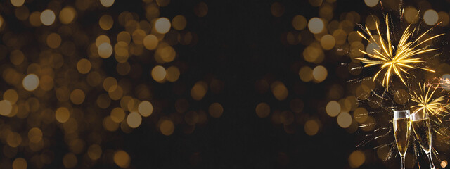 HAPPY NEW YEAR 2022 - Festive silvester background panorama banner long - Golden yellow firework and champagne classes toasting on black night texture with bokeh lights © Corri Seizinger
