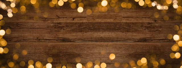 Frame of lights bokeh golden flares, isolated on rustic brown wooden texture - Holiday New Year's...