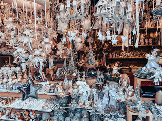 Austrian Christmas fairground. Glittery ceramic toys, metal candle holders candlesticks, stars, vintage balls, pine cones. Bazaar sale. Magical atmosphere. 