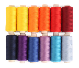 Set of colorful sewing threads on white background, top view