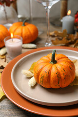 Beautiful autumn place setting and decor on wooden table, closeup