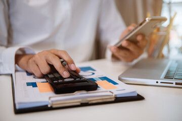 Fototapeta premium Business and financial concepts about office work. Analysts discuss business with a calculator as a tool.