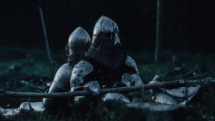 Two Medieval Knights Sitting on Battlefield amidst Dead Enemies. Last Surviving Crusaders,...