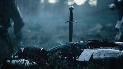 Shot of a Dark Age Battlefield: Dead Body With Stuck Sword. Brutal Fight to Death of Two Armored...