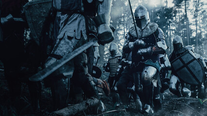 Epic Invading Army of Medieval Soldiers Marching Through Forest. Armored Warriors with Swords...
