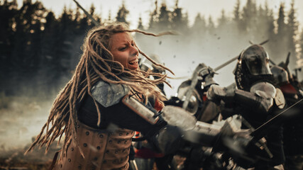 Epic Battlefield: Powerful Female Warrior Attacking, Fighting with Sword, Hitting Enemy with Deadly...