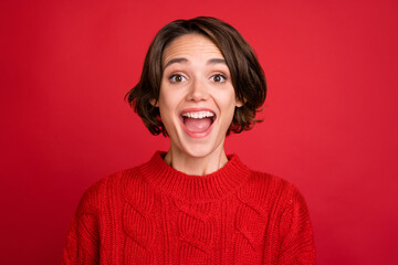 Photo portrait young woman staring amazed smiling overjoyed in sweater isolated bright red color background
