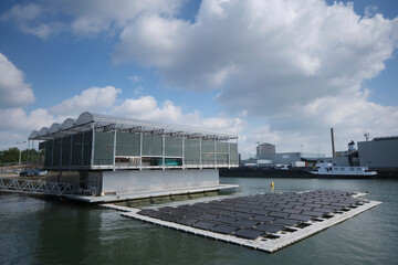 Rotterdam, The Netherlands. Panoramic view of the first floating dairy farm (offshore farming) in the world in the city environment with rowboat in front