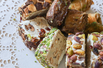 traditional Turkish sweets, baklava, lies on a beautiful napkin on the table. Treats, delicacies, nuts, nougat. Turkish sweets