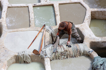 Painting the leather in Fez, the ancient tanneries in the heart of medina