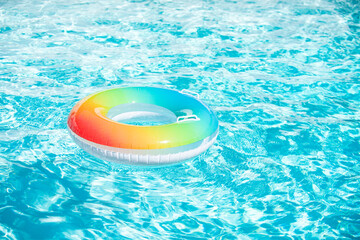 Pool float, floating in a blue swimming pool. Summer background.