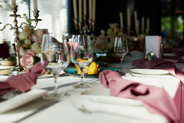 Beautiful festive table setting with candles and flowers.