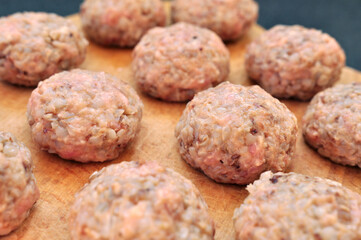 Tasty Meat balls with buckwheat on wooden board close up