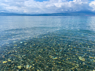 Absolutely transparent blue water, pebbles on the bottom, azure paradise, natural colors 