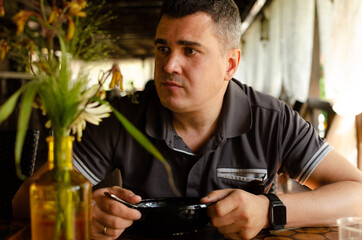 a man is waiting for an order in a beautiful cafe