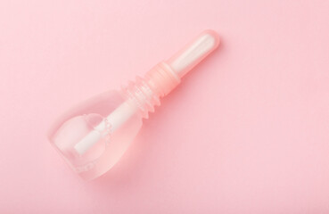 vaginal enema on pink baclground. Treatment of gynecological diseases. Pump for feminine hygiene. Woman health. Contraception method douche, lavement. Medical birth control. Planning pregnancy