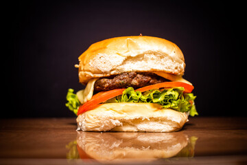 Handmade snack with black background and shiny wood table