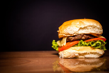 Handmade snack with black background and shiny wood table