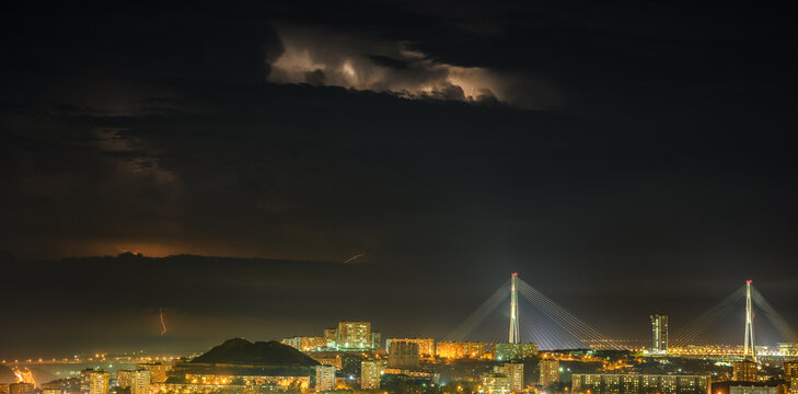 Lightning storm at night over city.