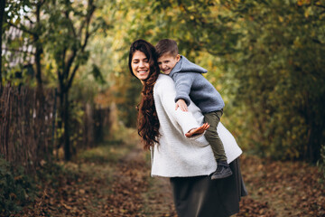 Mother with little son in an autumn park