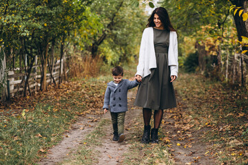 Mother with little son in an autumn park