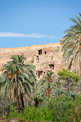 Fototapeta na wymiar Scenic view of Old stone houses, Palm trees Oasis , Mountains from Ghoufi Canyon in the Aures region, Algeria