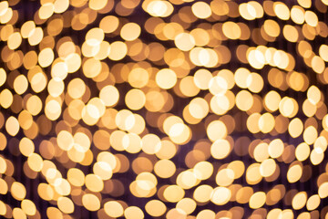 Abstract golden bokeh dark background.
